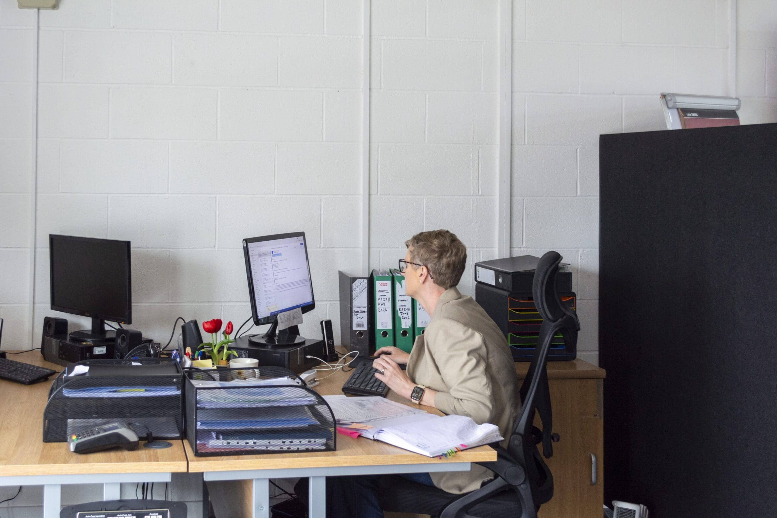 Member of Staff sitting at their desk working on a computer